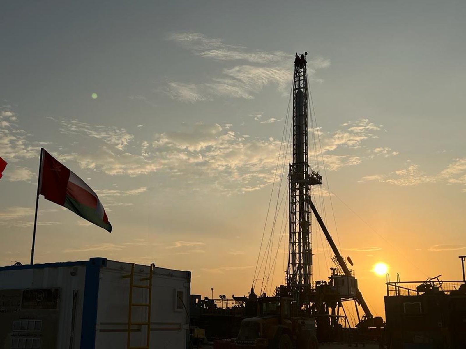 Mafraq Energy drilling rig at sunset with the Omani flag